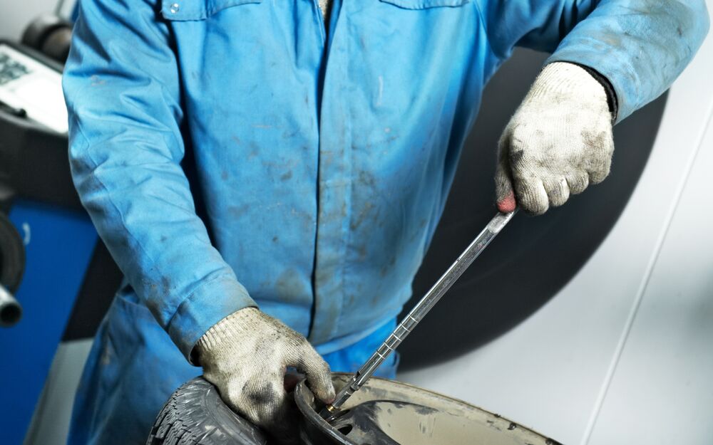 Tyre technician repairing a puncture